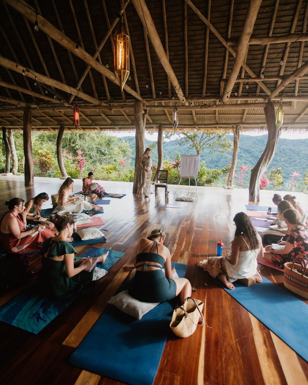 Two walkers moving along a wide mountain town sidewalk